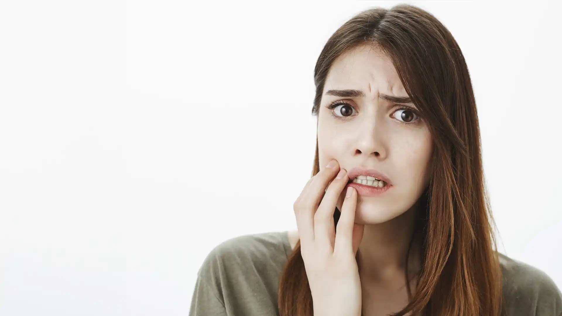 Woman holding her cheek with a toothache